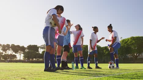 female soccer team in break time talking on soccer field. 4k