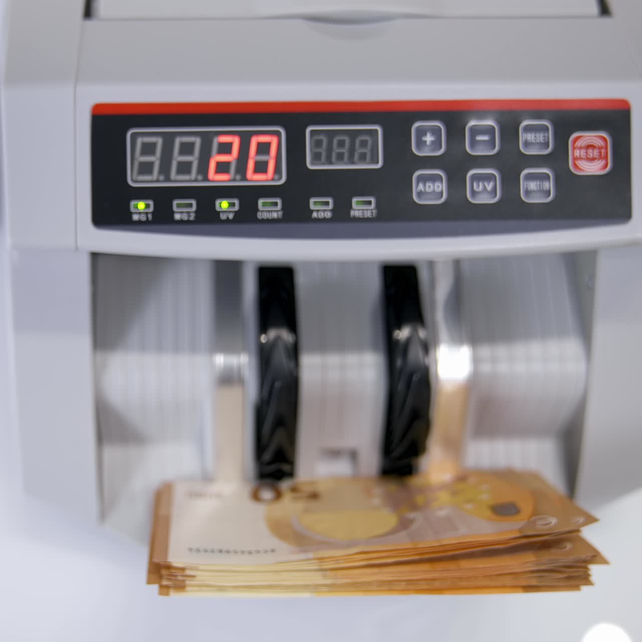 Euro bills going through the counting mechanism, close up