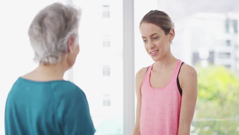 Un-Instructor-De-Fitness-Que-Ayuda-A-Una-Mujer-Mayor