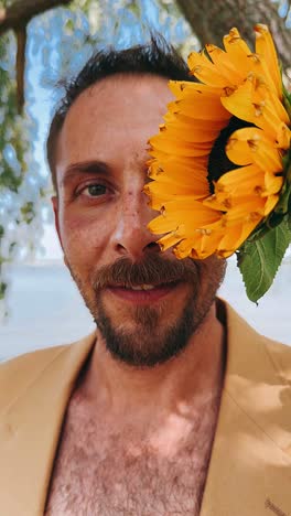 man with sunflower over eye