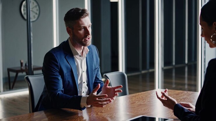 Professional Businessman Speaking and Gesturing in a Corporate Meeting