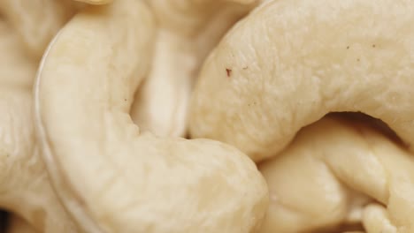 smooth camera movement over a handful of cashew nuts.