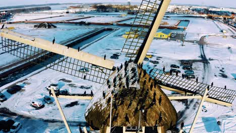 flock of great cormorant sit on windmill in harderwijk, netherlands, aerial close up view