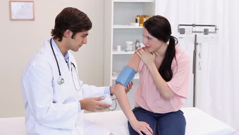 a doctor taking the patients blood pressure