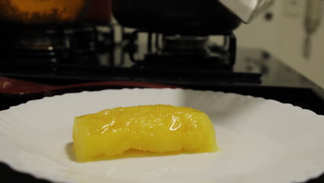 video of a person putting salt om a cooked cassava-manioc.