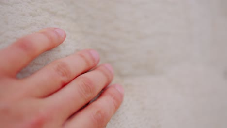 close up of hand of person touching pamukkale calcium rocks in turkey