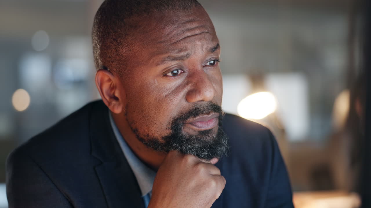 Reading, thinking and black man at computer