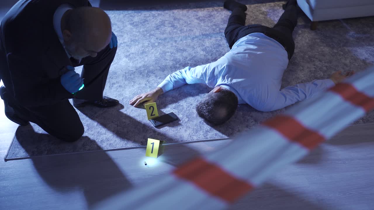 Detective looking at the body of the murdered victim at home.