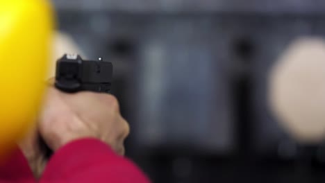 person practicing with a handgun at a shooting range