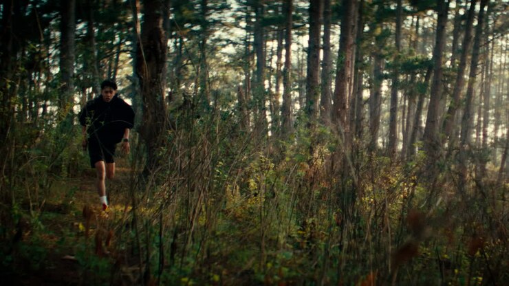 Boy Running Through the Woods