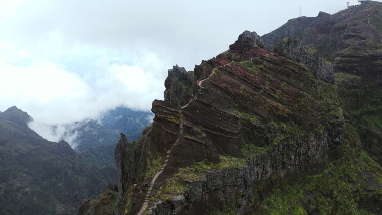 Wooden stairs climbing the mountain peak of Pico do Arieiro, Madeira island, Portugal, aerial view