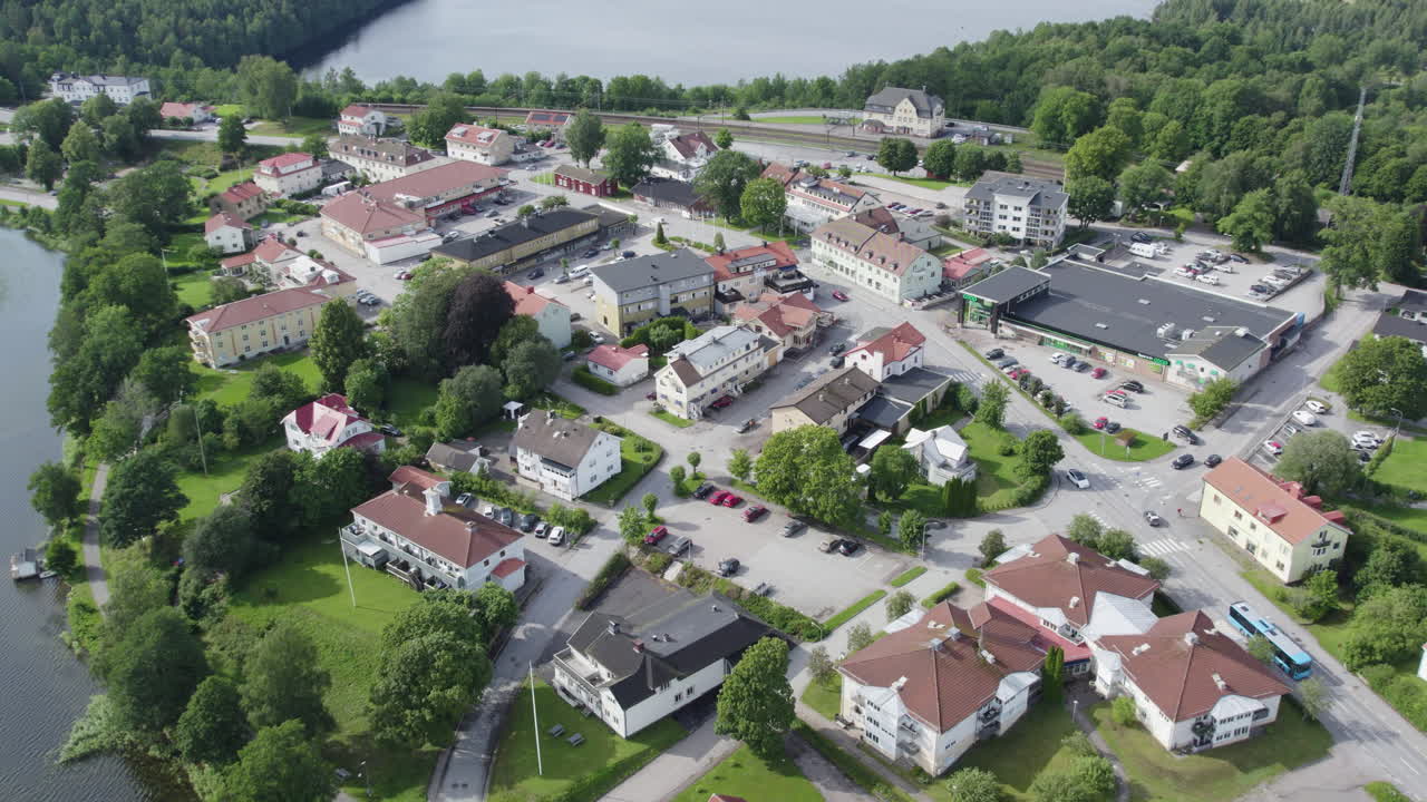A small swedish town with houses, greenery, and a central square, aerial view