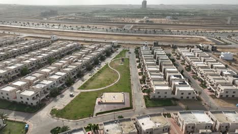 Aerial-drone-view-of-neat-rows-of-uniform-houses-in-Bahria-Town,-Karachi,-Pakistan