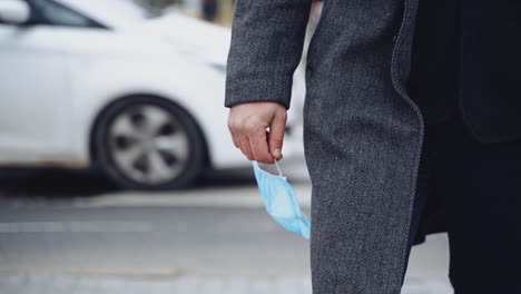 surgical masks to prevent sickness. close up of man with protective mask walking during pandemic covid-19