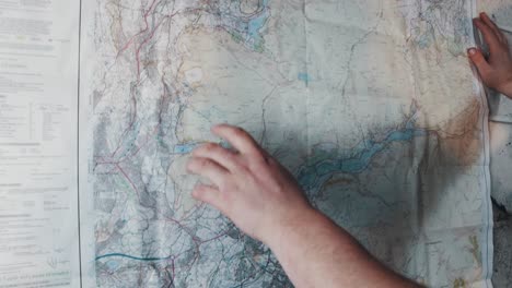 a man searching for a location on a wall map