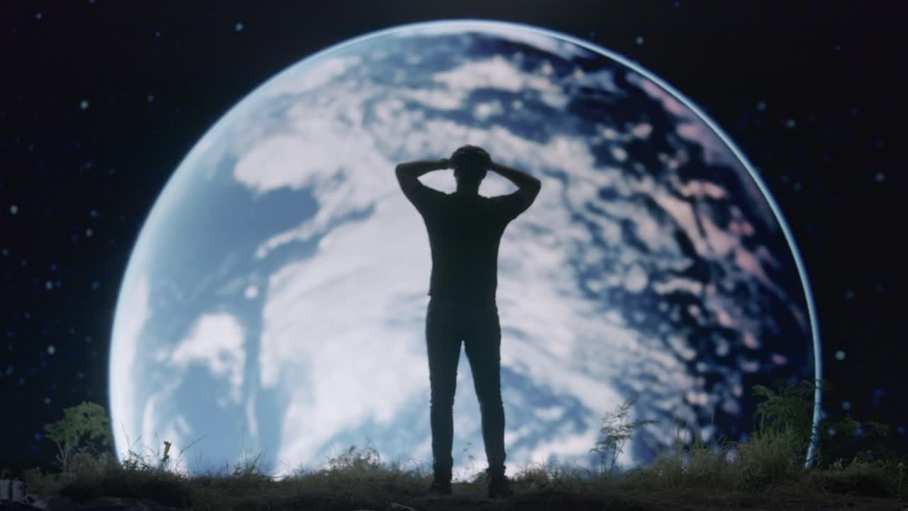 Man Kneeling Before Earth at Night