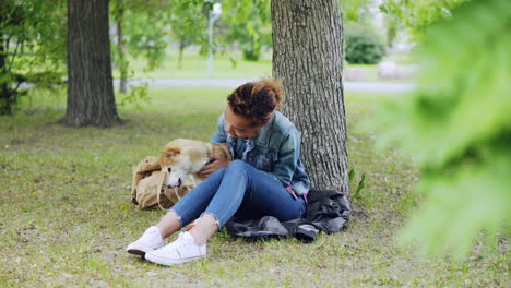 woman and dog relaxing in a park