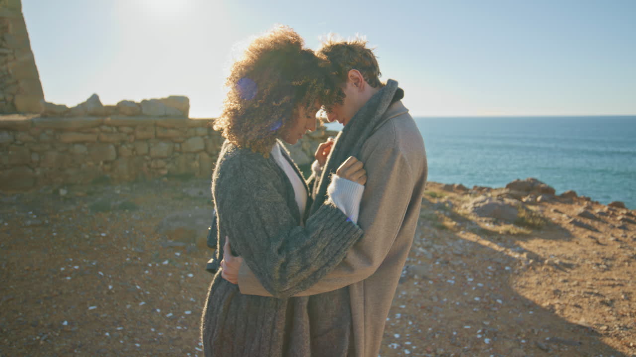 Romantic lovers embracing evening sandy beach closeup. Couple cuddling together