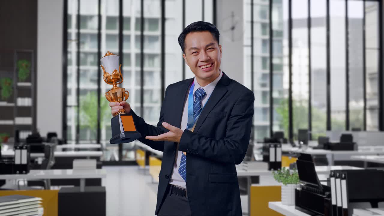 Businessman Holding Trophy in Office