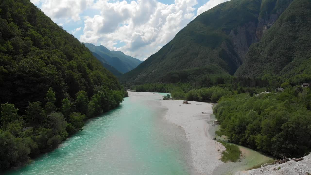 drone flying backwards above soca river near bovec, slovenia, cloudy summer day