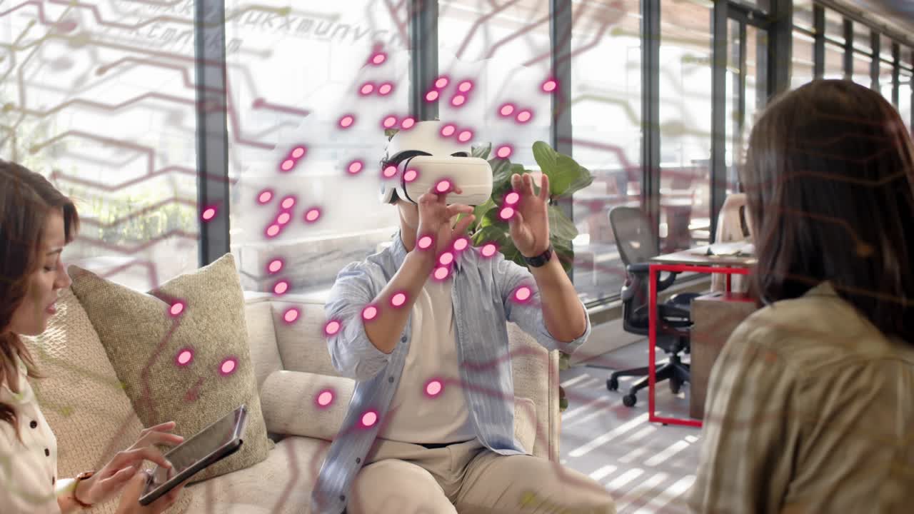 Man wearing VR headset initiating tech demo, women using tablet and watching, pink overlay pulsing