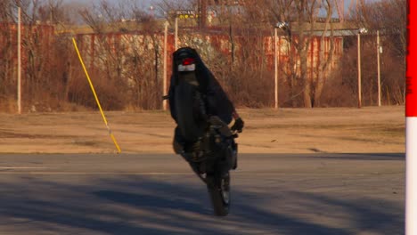 A-rider-performs-stunts-on-a-motorcycle-in-a-parking-lot-3