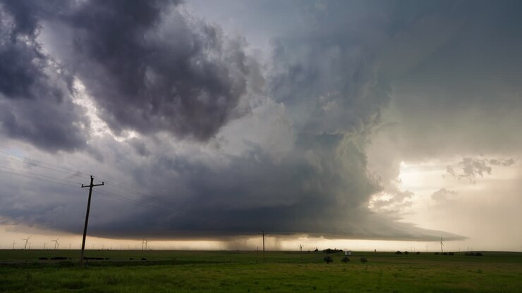 Dramatic Supercell Thunderstorm Over Rural Landscape with Wind Farm