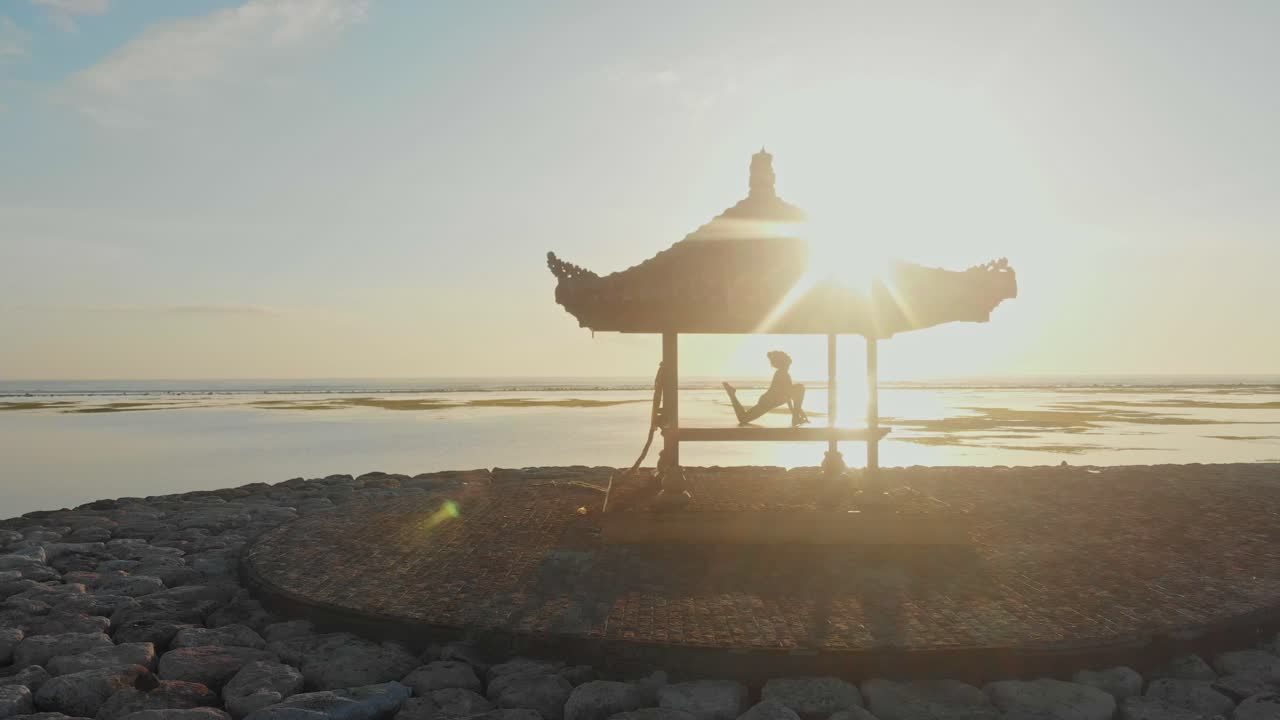 Vista aerea della spiaggia di Sanur con mare calmo e alba sull'Oceano Indiano a Bali Indonesia.