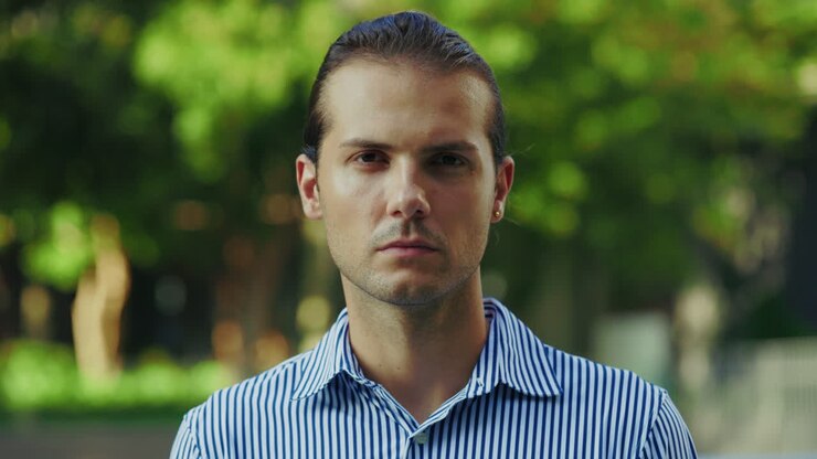 Close-up portrait of a serious man outdoors
