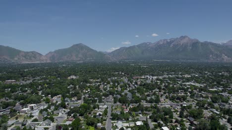 wasatch mountains with suburban residential neighborhood of salt lake city, utah - midday aerial view with copy space in sky