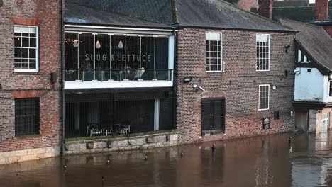 the river ouse floods under slug and lettuce, york, united kingdom