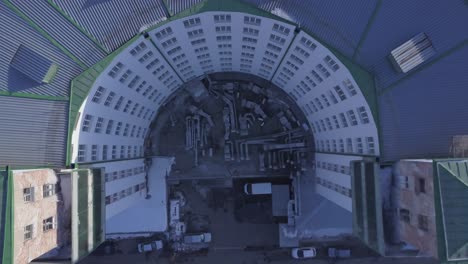 aerial view of a curved multi-story residential building under construction