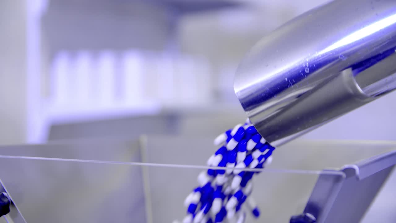 Close up of a pharmaceutical worker pouring pills for COVID-19 treatment