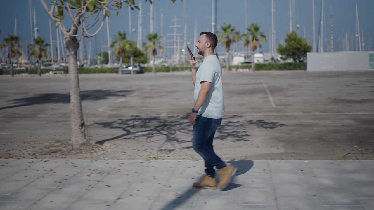 Man Walking and Talking on Phone at Marina