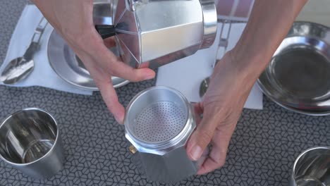 preparing moka pot coffee on open air campsite