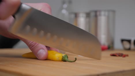 Cutting-a-Yellow-Chili-Pepper,-Static-Camera