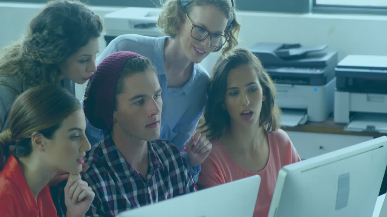 Team leaning in and pointing at monitor initiating engagement icons and metrics rising in marketing