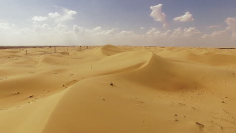 an awe-inspiring sight unfolds at al wahthba, abu dhabi, where the sand dunes gleam with their stunning yellowish-brown hue, serving as the backdrop for camel races