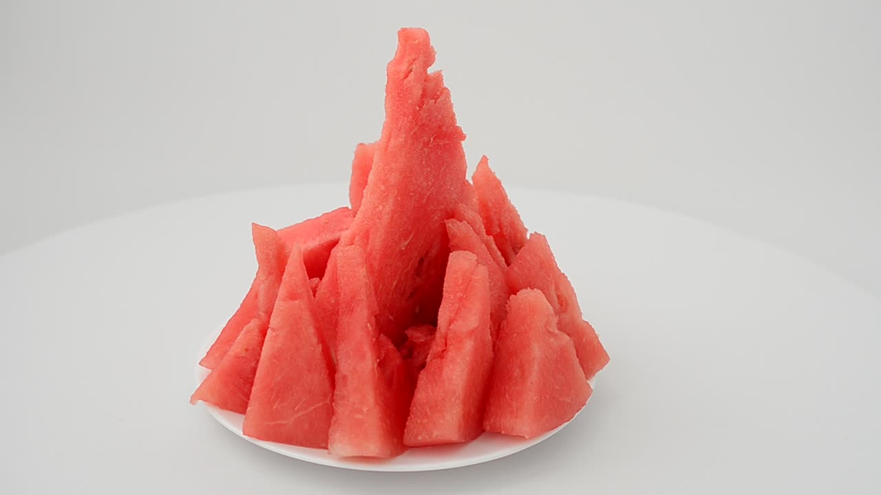 Shooting of a watermelon on a white background. Shooting in the movement