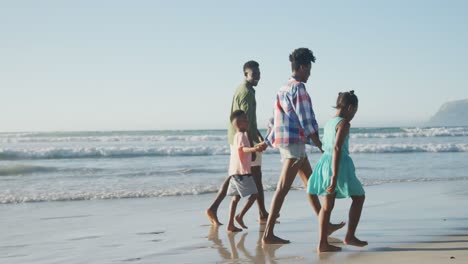 Glückliches-Afroamerikanisches-Paar,-Das-Mit-Tochter-Und-Sohn-Am-Sonnigen-Strand-Spaziert