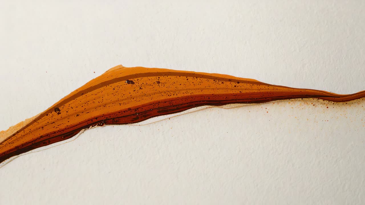 Starting at left edge, layered rust pigment streak stabilizing on paper, forming speckled dark rim