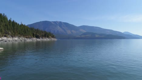 Woman-performing-yoga-on-at-lake-shore-4k