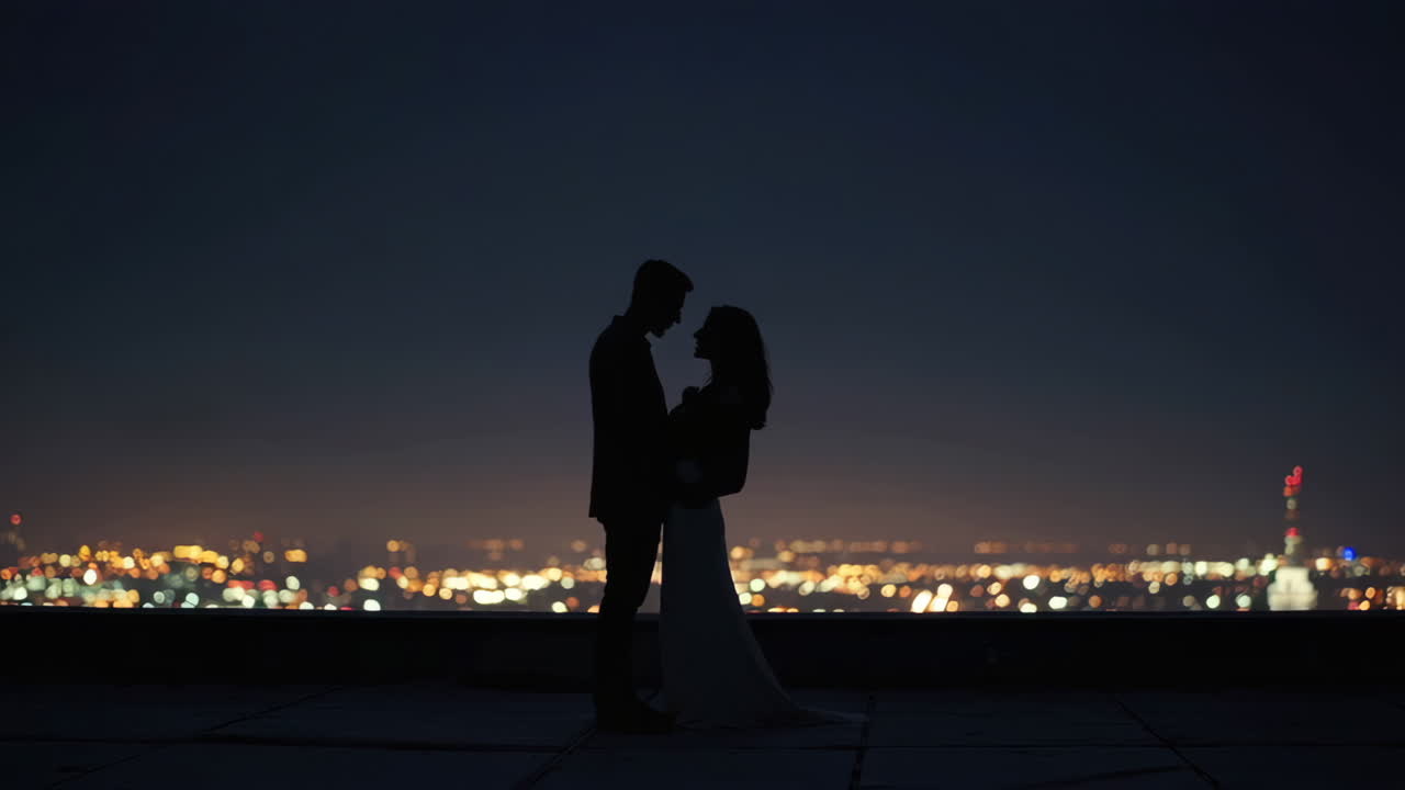 Couple in Silhouette at Night on Rooftop