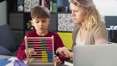 video of mother teaches her son to count with an abacus