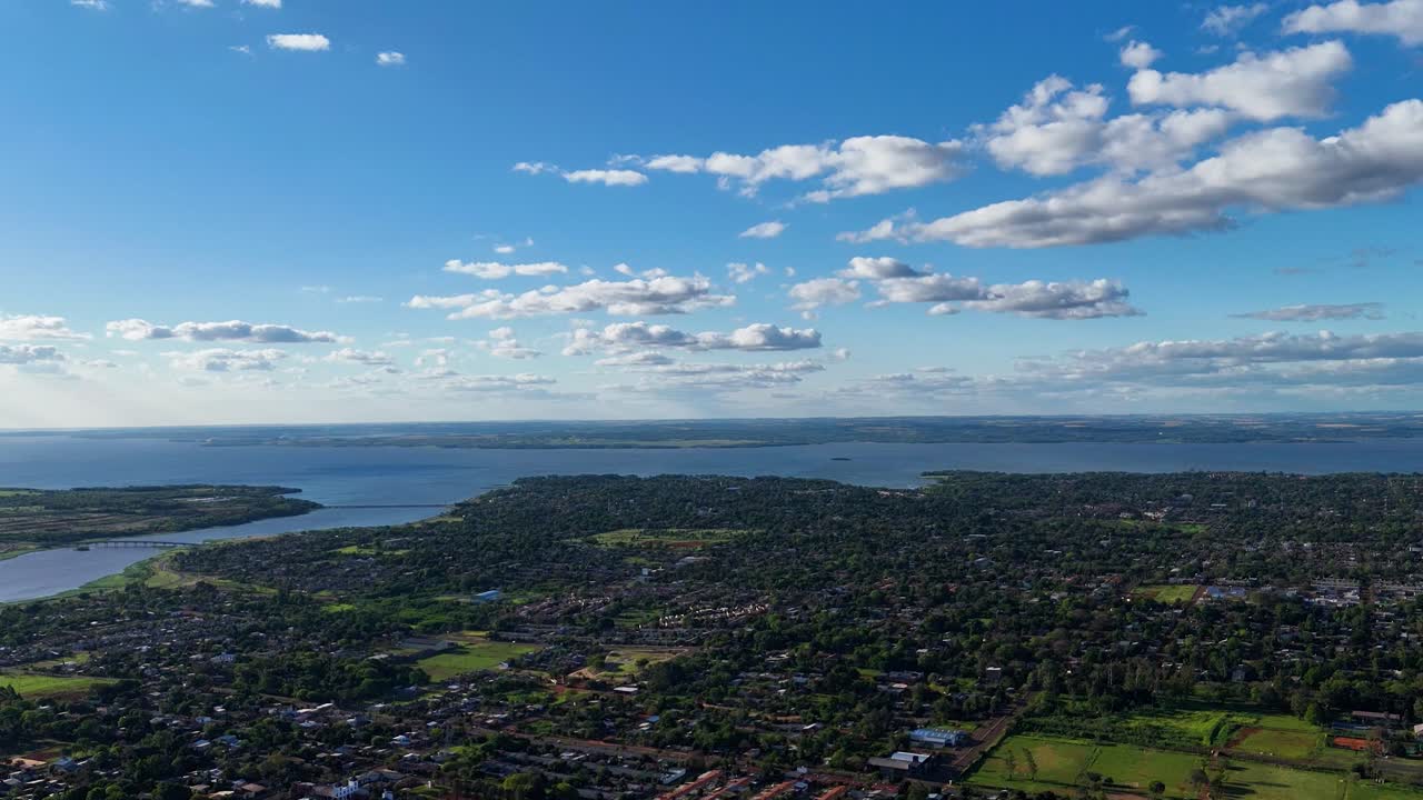 A breathtaking hyperlapse capturing the dynamic cityscape of Posadas and its neighborhoods, set against the stunning backdrop of the Paran&aacute; River