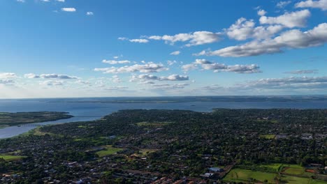 a breathtaking hyperlapse capturing the dynamic cityscape of posadas and its neighborhoods, set against the stunning backdrop of the paraná river