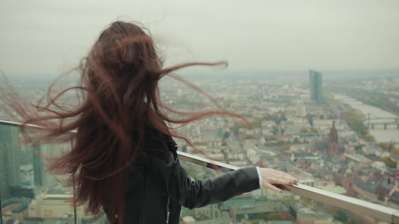 woman approaches transparent partition and looks thoughtfully into distance