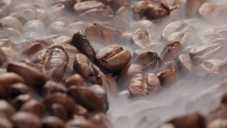 Close-up-of-seeds-of-coffee.-Fragrant-coffee-beans-are-roasted-smoke-comes-from-coffee-beans.