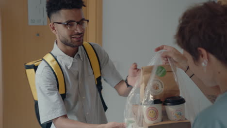 delivery man bringing food to female customer at home