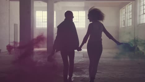 fashionable young man and woman in an abandoned warehouse